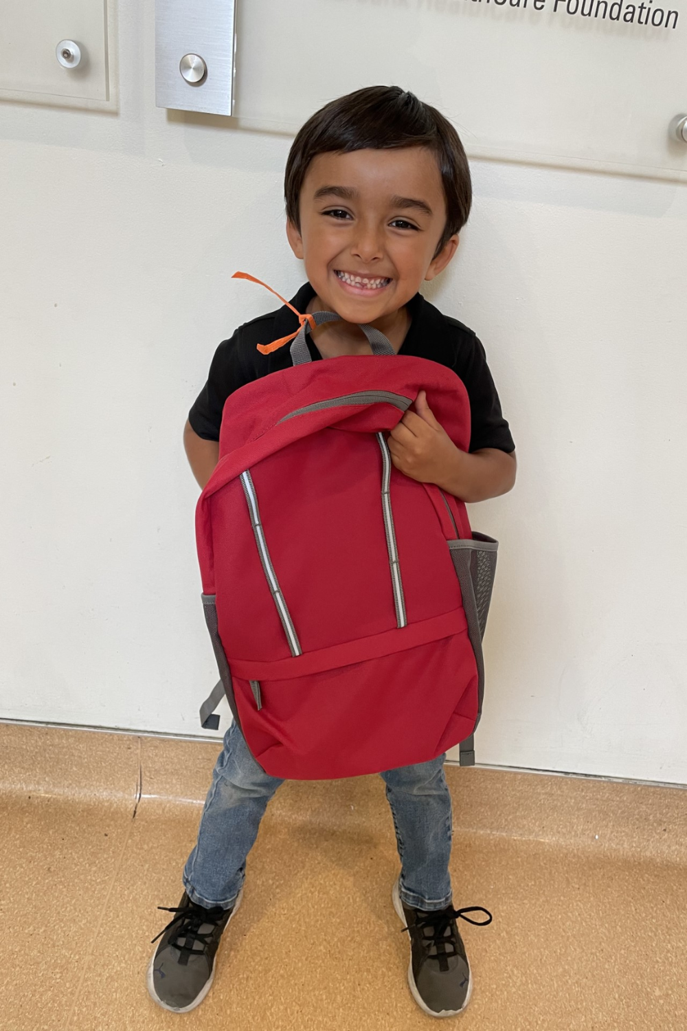 Young client holding backpack